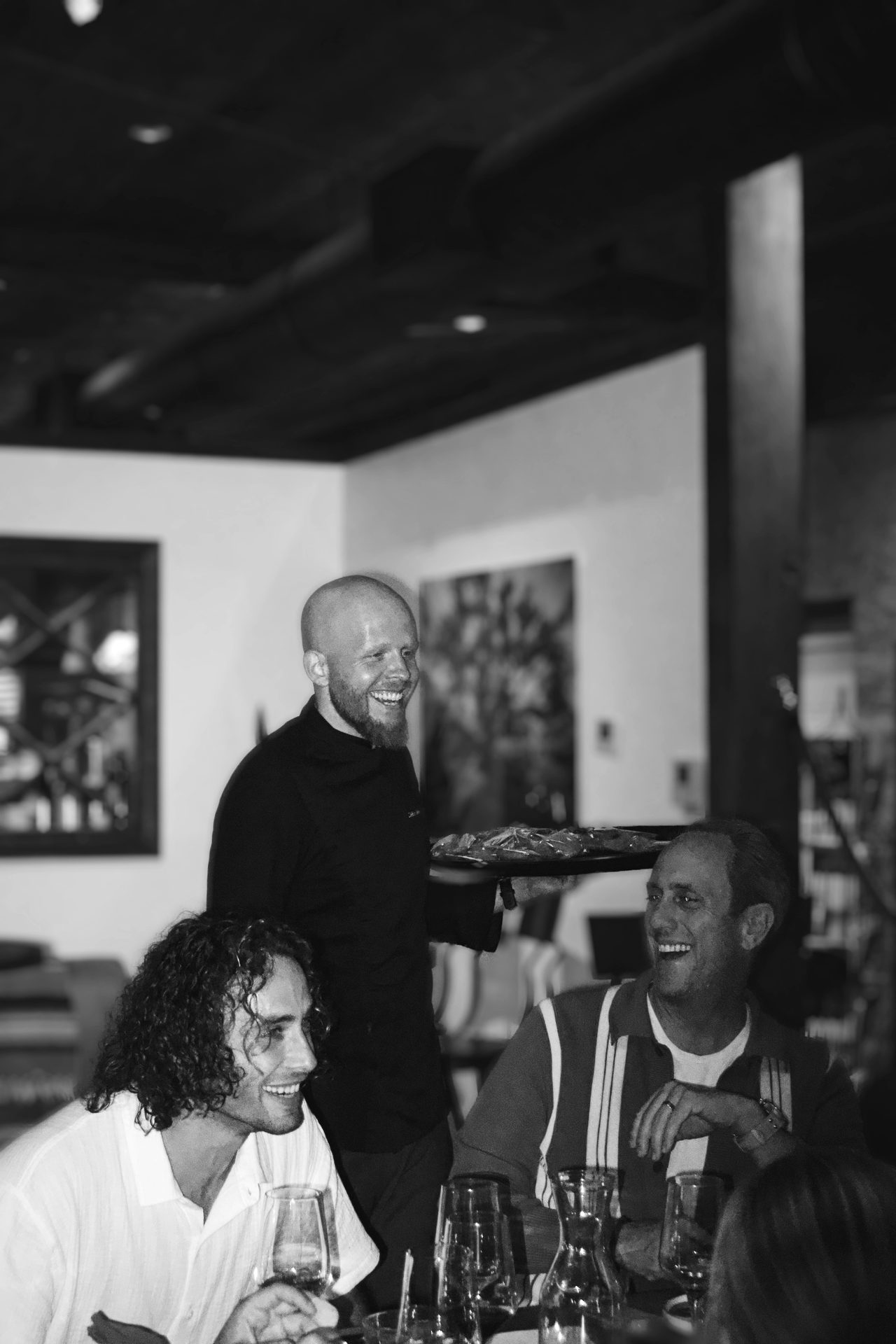 Chef Cedric Reiter talking with guests at the dinner table