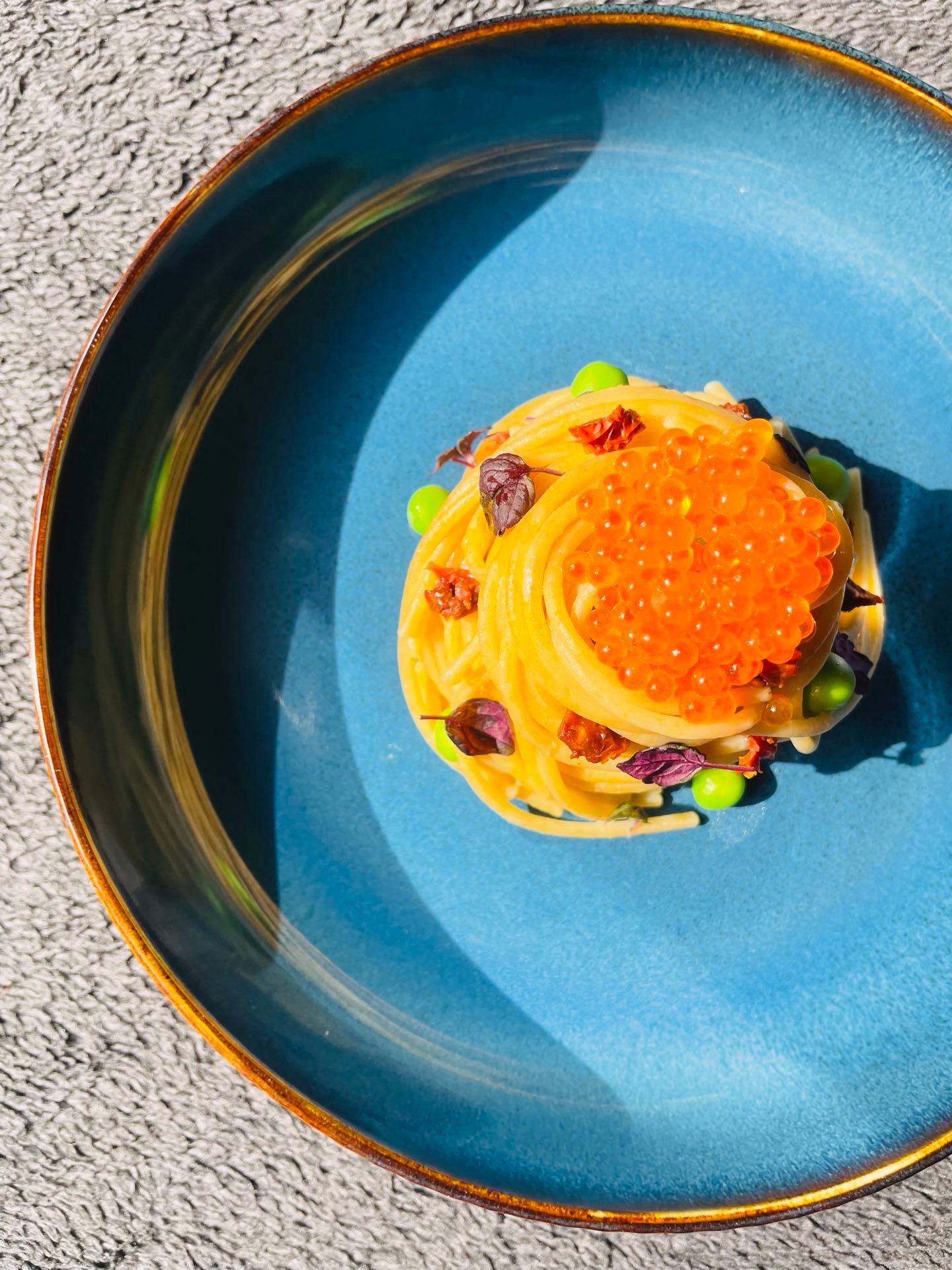 Saffron pasta nest topped with roe