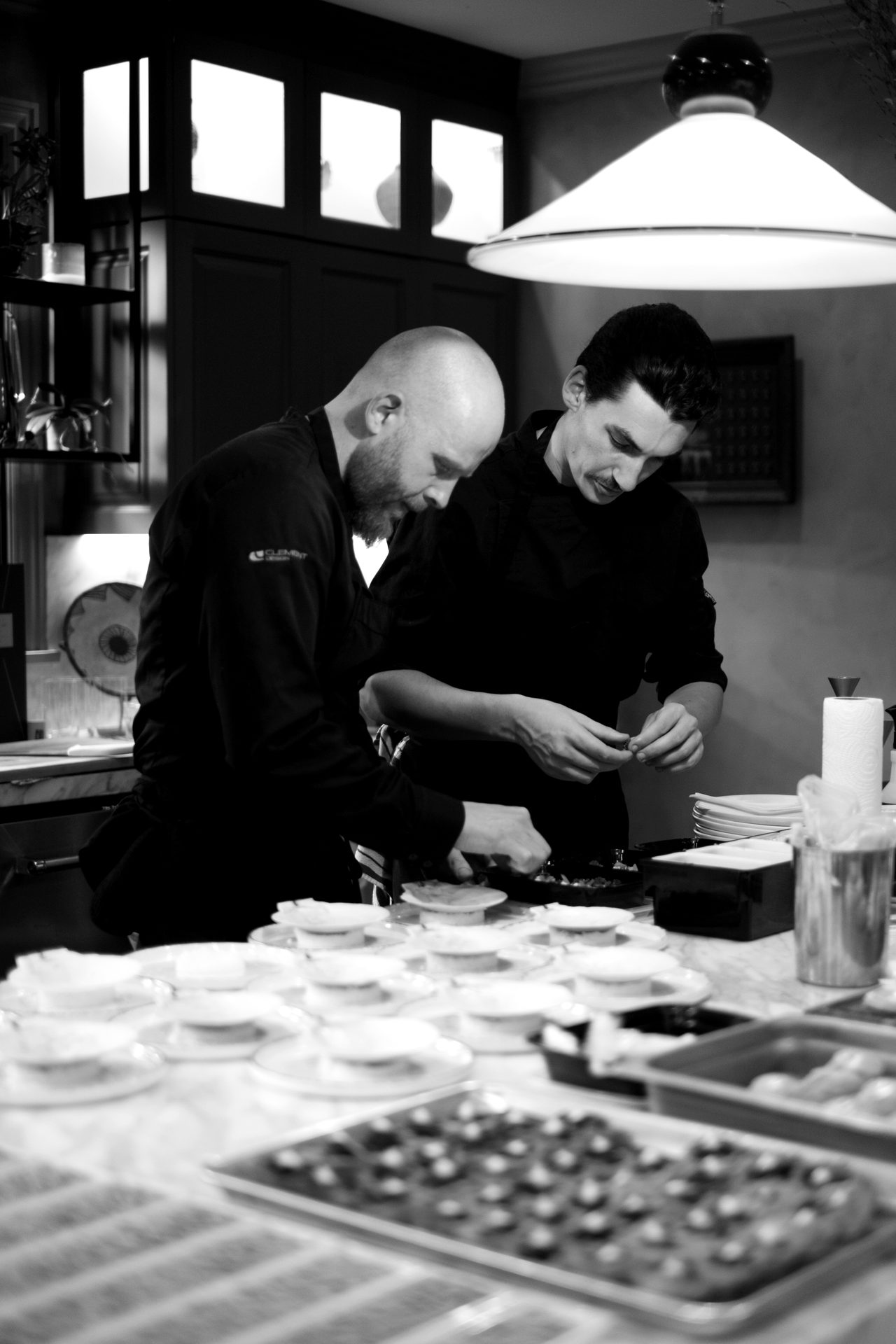 Two chefs working side by side during dinner preparation